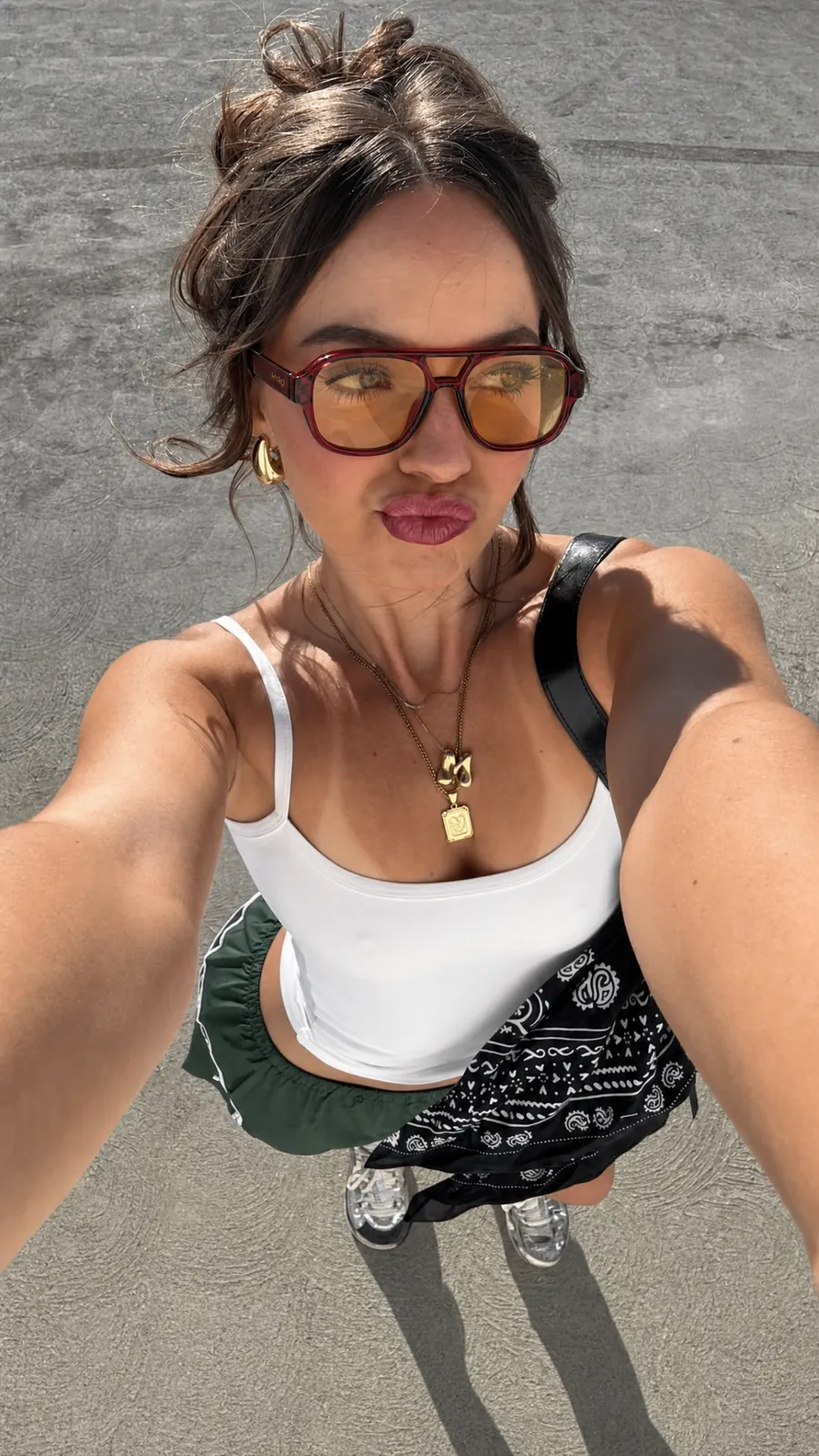 HYRO model wearing sunglasses on a bright beach
