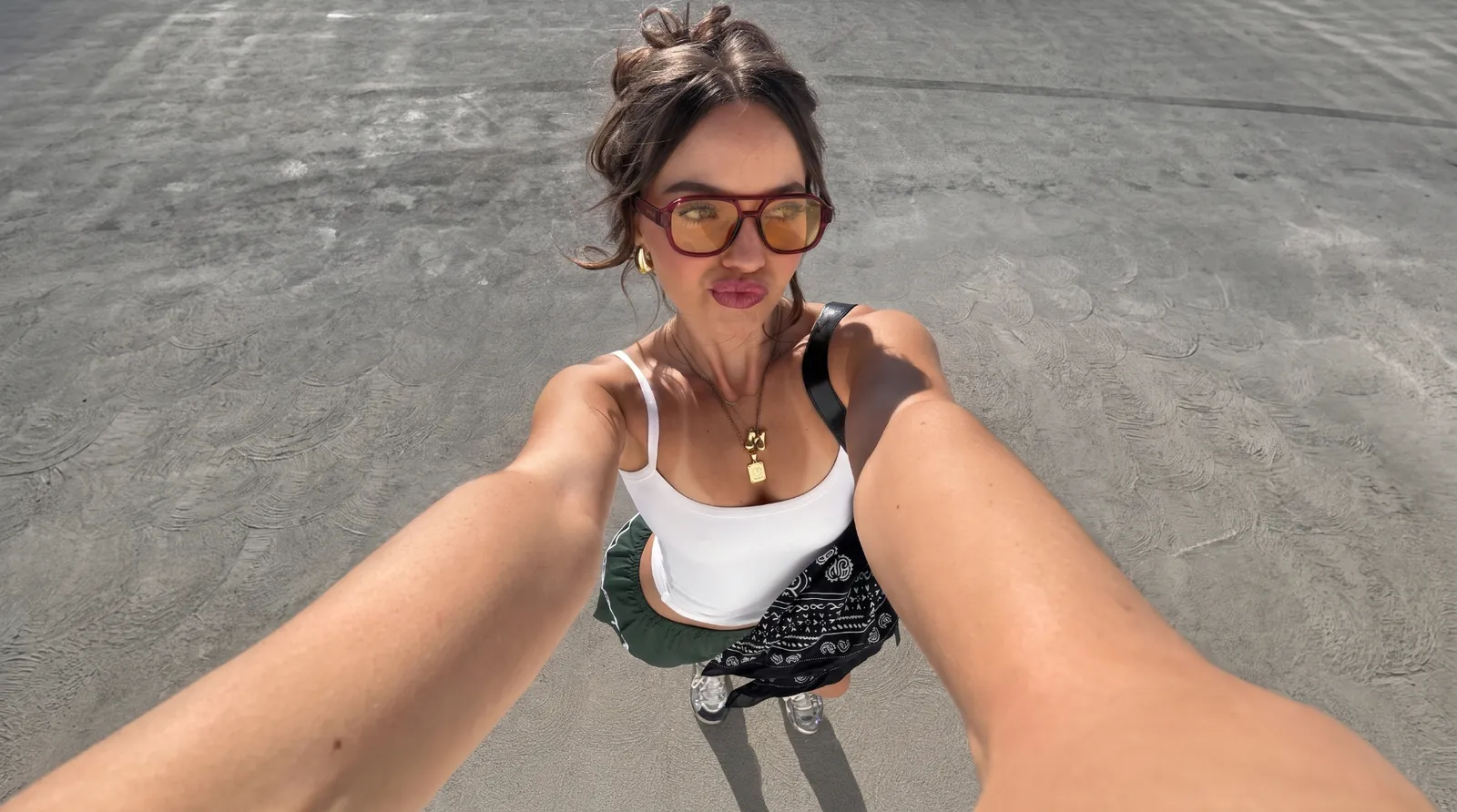 HYRO model wearing sunglasses on a bright beach