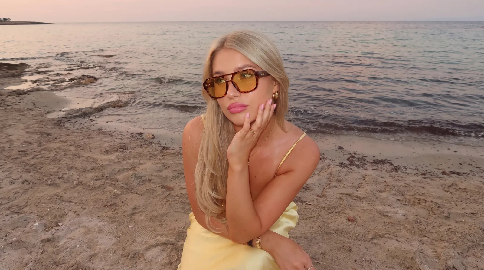Model wearing HYRO sunglasses on the beach
